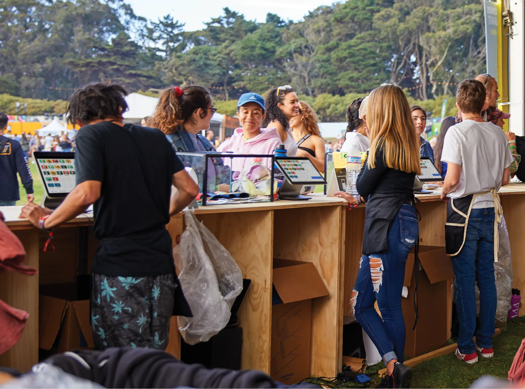 guests ordering at an outdoor event counter with POS devices